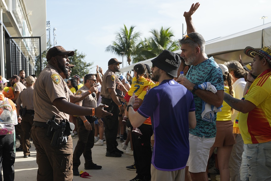 Police speak with fans outside of the Copa America final.
