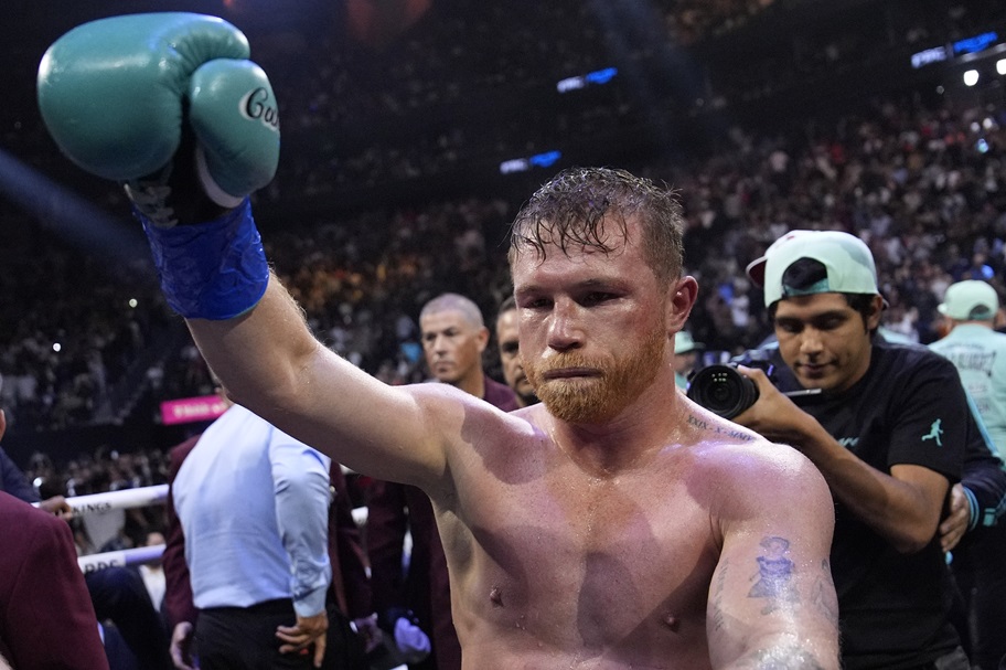 Canelo Alvarez celebrates after beating Jaime Munguia.