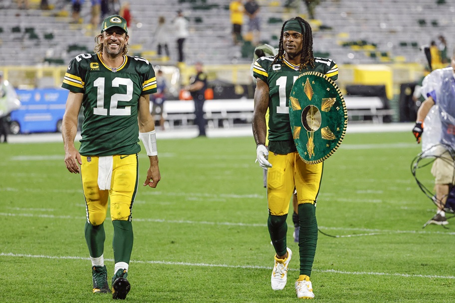 Aaron Rodgers and Davante Adams walk off the field after an NFL game.