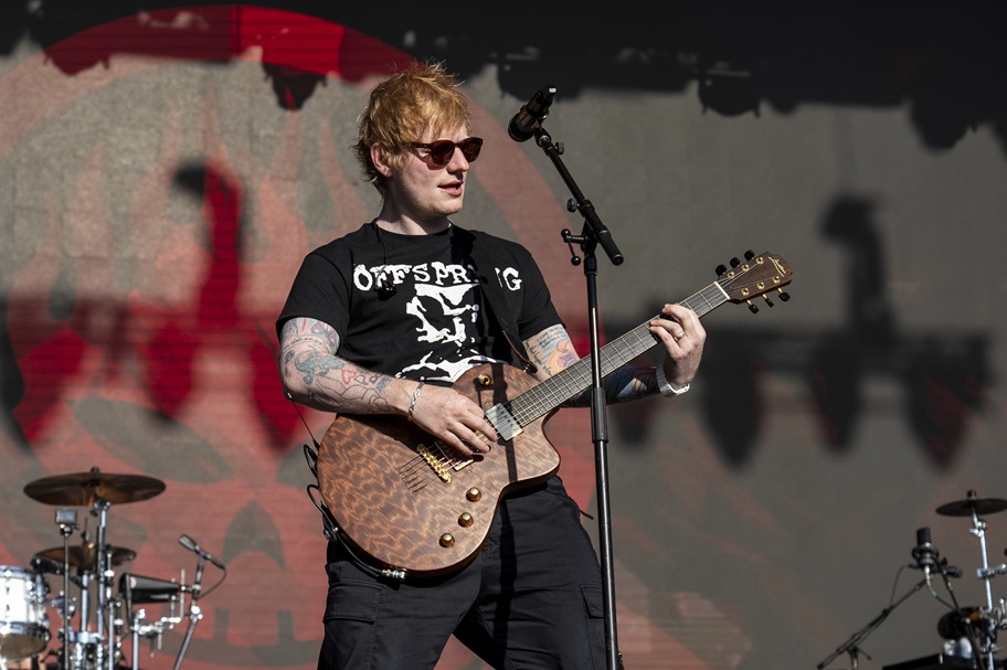 Ed Sheeran plays at a concert.