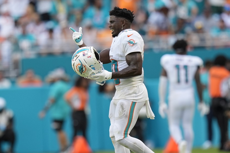 Tyreek Hill makes a gesture on an NFL field
